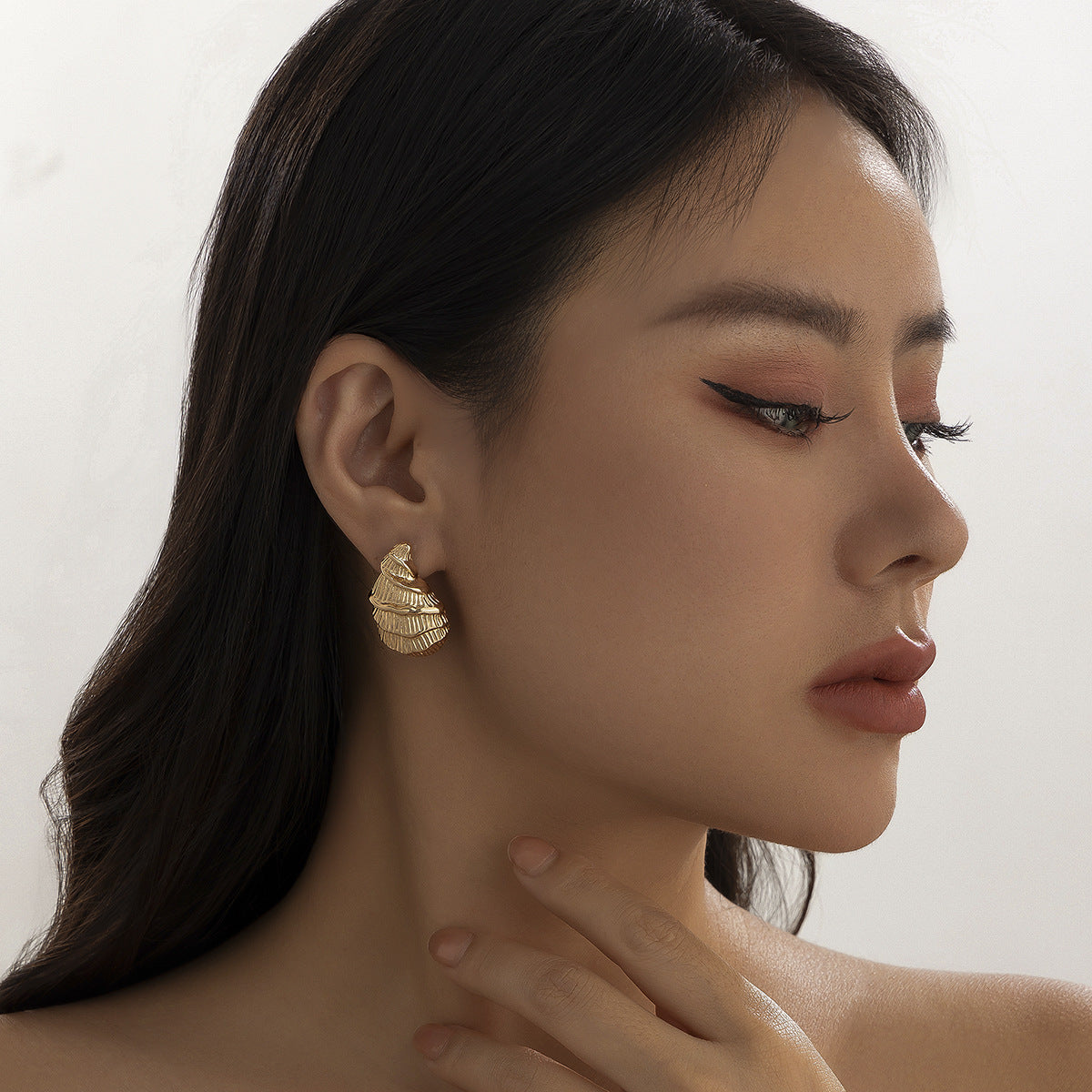 Minimalist and niche spiral patterned conch earrings