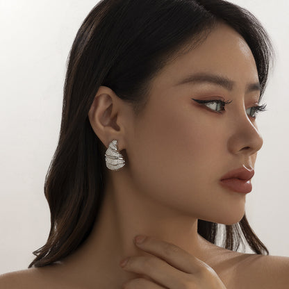 Minimalist and niche spiral patterned conch earrings